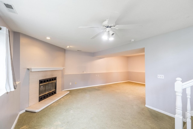 2316 SE 17th St, Des Moines, IA 50320 - unfurnished living room featuring carpet, a tiled fireplace, and ceiling fan