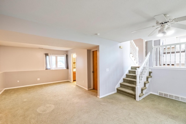 2316 SE 17th St, Des Moines, IA 50320 - below grade area with carpet, a ceiling fan, and stairs