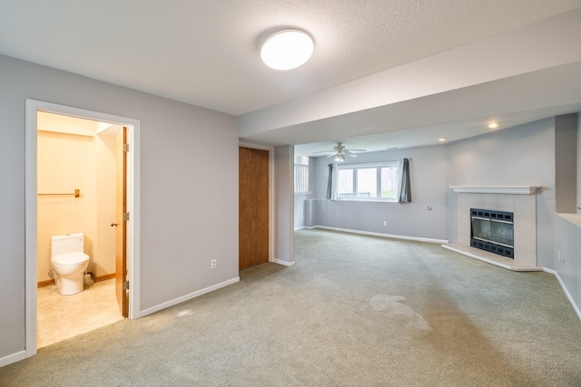 2316 SE 17th St, Des Moines, IA 50320 - unfurnished living room featuring carpet flooring, heating unit, a ceiling fan, a glass covered fireplace, and a textured ceiling