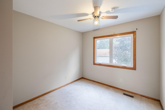 2316 SE 17th St, Des Moines, IA 50320 - empty room featuring light carpet, ceiling fan, and a smoke detector
