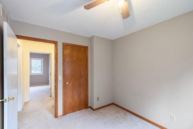2316 SE 17th St, Des Moines, IA 50320 - unfurnished bedroom with light colored carpet, a closet, and a ceiling fan