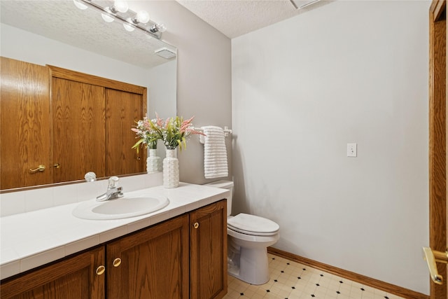 8001 Sheridan Dr, Urbandale, IA 50322 - bathroom featuring vanity, tile patterned floors, and a textured ceiling