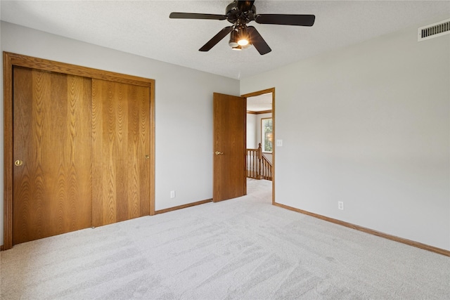 8001 Sheridan Dr, Urbandale, IA 50322 - unfurnished bedroom with a closet, carpet, and ceiling fan