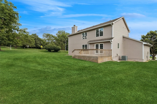 8001 Sheridan Dr, Urbandale, IA 50322 - back of house featuring a chimney, a wooden deck, and a lawn