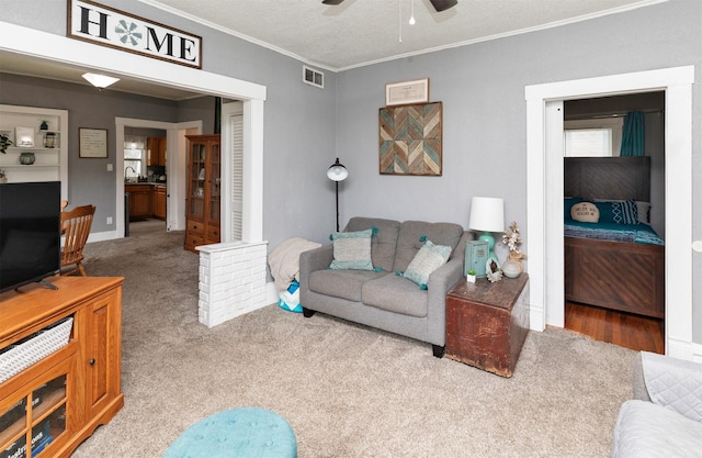420 9th St, West Des Moines, IA 50265 - living area with carpet flooring, crown molding, and ceiling fan
