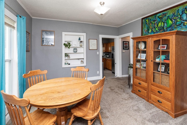 420 9th St, West Des Moines, IA 50265 - dining area with crown molding, light colored carpet, and a textured ceiling
