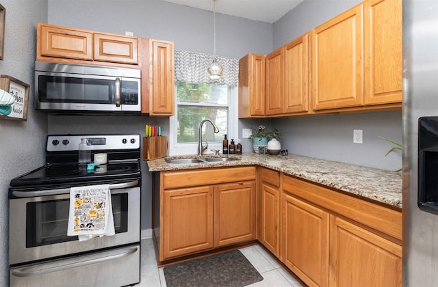 420 9th St, West Des Moines, IA 50265 - kitchen with stainless steel appliances, light stone countertops, and light tile patterned flooring