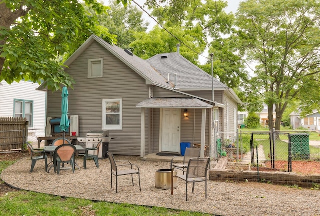 420 9th St, West Des Moines, IA 50265 - back of house with roof with shingles and a patio