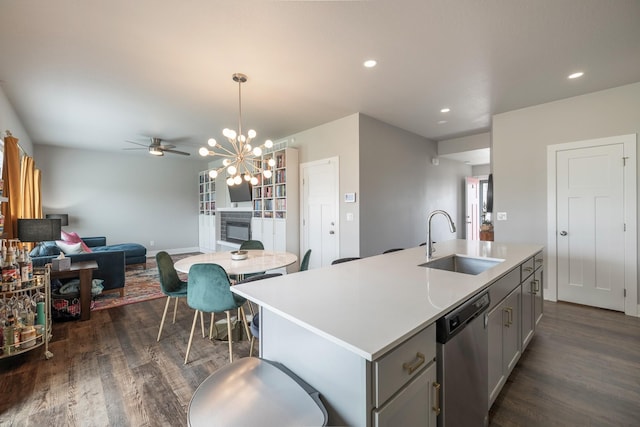 1504 NE Savana Dr, Grimes, IA 50111 - kitchen featuring stainless steel dishwasher, open floor plan, gray cabinets, dark wood-type flooring, and light countertops