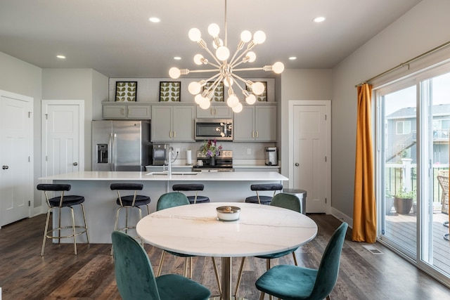 1504 NE Savana Dr, Grimes, IA 50111 - dining area featuring a chandelier, dark wood finished floors, and recessed lighting
