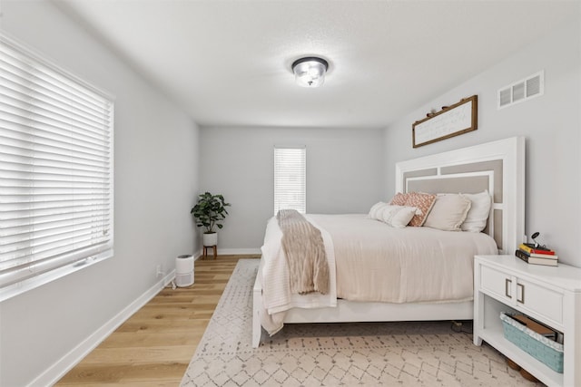 8113 Hammontree Cir, Urbandale, IA 50322 - bedroom featuring light wood-style floors and baseboards
