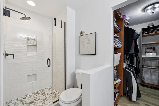 8113 Hammontree Cir, Urbandale, IA 50322 - bathroom with a shower stall, wood finished floors, and a spacious closet