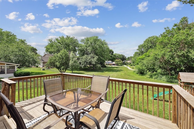 8113 Hammontree Cir, Urbandale, IA 50322 - deck featuring outdoor dining space, a lawn, and view of scattered trees