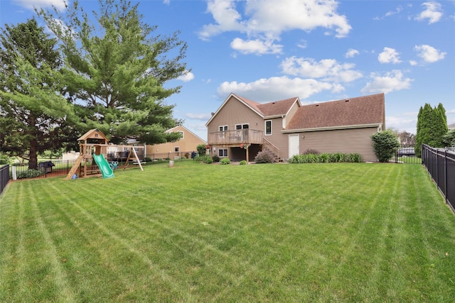 8113 Hammontree Cir, Urbandale, IA 50322 - back of property with a fenced backyard, a playground, stairway, and a deck