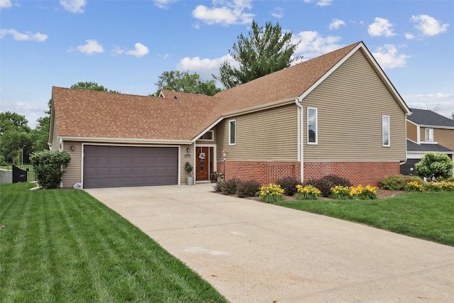 8113 Hammontree Cir, Urbandale, IA 50322 - view of front of property with an attached garage, a front lawn, driveway, and brick siding