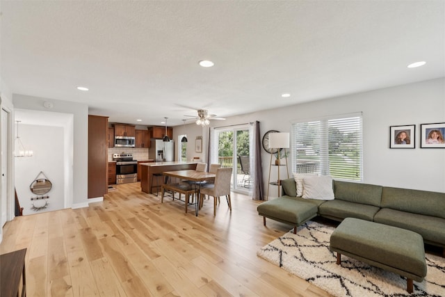 8113 Hammontree Cir, Urbandale, IA 50322 - living room featuring recessed lighting, light wood-type flooring, and a ceiling fan