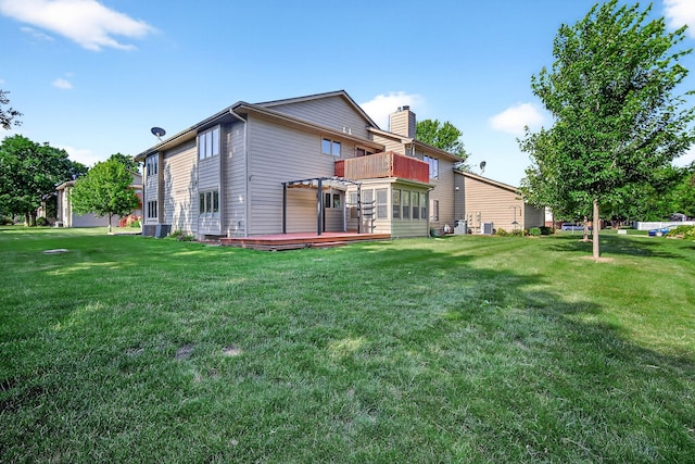 4719 84th St Unit A, Urbandale, IA 50322 - back of property featuring a wooden deck, a lawn, a chimney, and a pergola