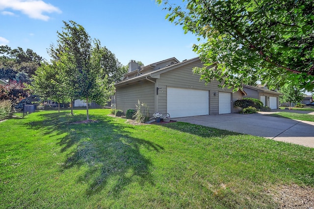 4719 84th St Unit A, Urbandale, IA 50322 - view of property exterior with a lawn, a chimney, and driveway
