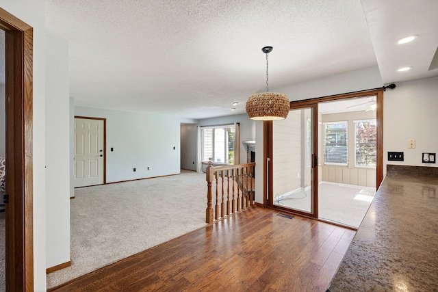 4719 84th St Unit A, Urbandale, IA 50322 - empty room featuring wood finished floors, a textured ceiling, and recessed lighting