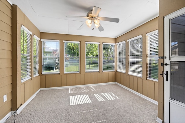 4719 84th St Unit A, Urbandale, IA 50322 - unfurnished sunroom with carpet, french doors, and wood walls