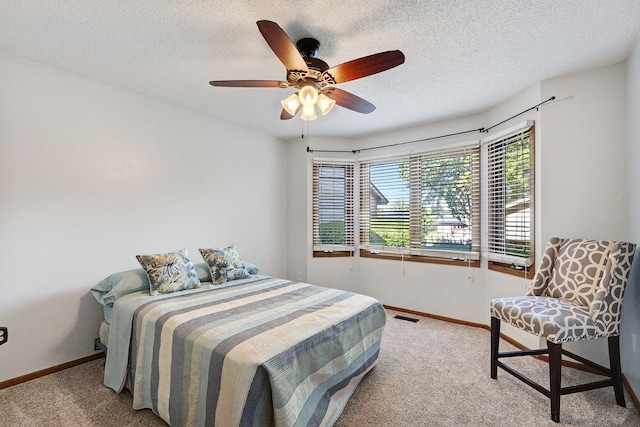 4719 84th St Unit A, Urbandale, IA 50322 - carpeted bedroom with a textured ceiling and ceiling fan