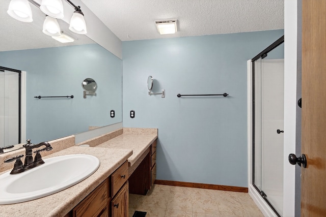 4719 84th St Unit A, Urbandale, IA 50322 - bathroom with vanity, a stall shower, a textured ceiling, and tile patterned flooring