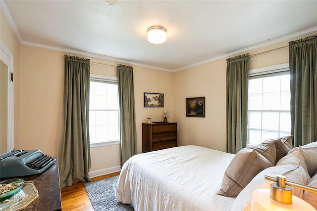 2625 38th St, Des Moines, IA 50310 - bedroom featuring light wood-type flooring, ornamental molding, and multiple windows
