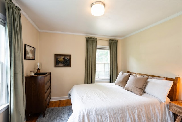 2625 38th St, Des Moines, IA 50310 - bedroom featuring crown molding and dark wood-style flooring