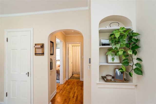 2625 38th St, Des Moines, IA 50310 - hall featuring ornamental molding, wood finished floors, and arched walkways