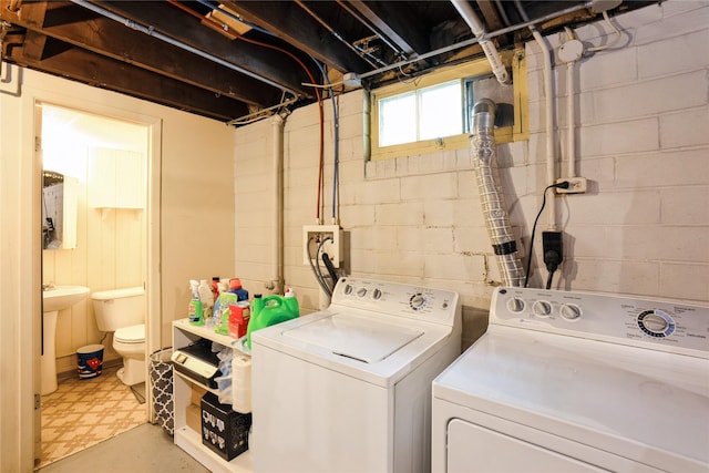 2625 38th St, Des Moines, IA 50310 - laundry area with washing machine and dryer, tile patterned floors, and concrete block wall