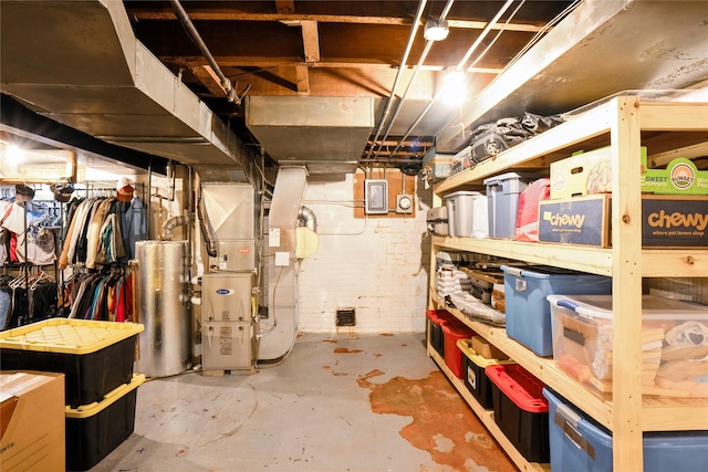 2625 38th St, Des Moines, IA 50310 - unfinished basement with gas water heater, heating unit, and electric panel
