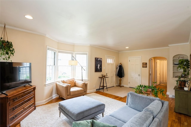 2625 38th St, Des Moines, IA 50310 - living room with arched walkways, wood finished floors, crown molding, and recessed lighting