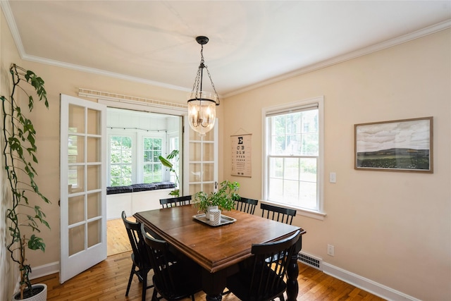 2625 38th St, Des Moines, IA 50310 - dining space featuring wood finished floors, ornamental molding, and a chandelier