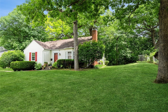 2625 38th St, Des Moines, IA 50310 - view of front of house featuring a chimney and a shingled roof