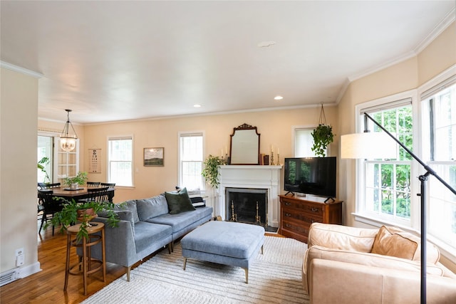 2625 38th St, Des Moines, IA 50310 - living room with crown molding, plenty of natural light, wood finished floors, a fireplace, and recessed lighting