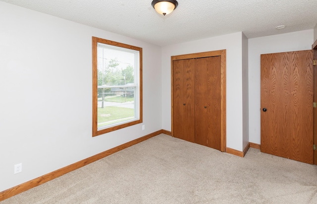 3948 43rd St, Des Moines, IA 50310 - unfurnished bedroom with a closet, carpet floors, and a textured ceiling