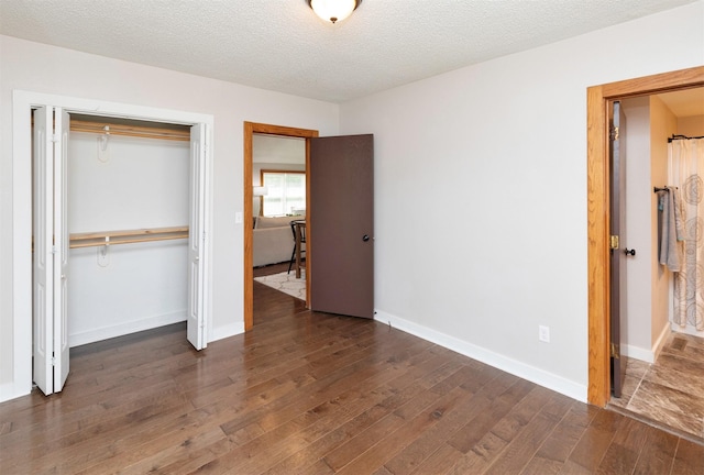 3948 43rd St, Des Moines, IA 50310 - unfurnished bedroom featuring a closet, wood finished floors, and a textured ceiling