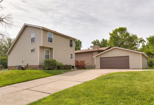 3948 43rd St, Des Moines, IA 50310 - view of front facade with a detached garage, a front lawn, and an outbuilding