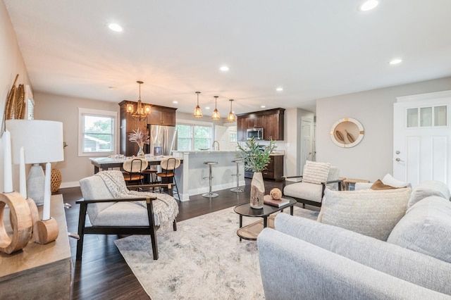 3817 80th St, Urbandale, IA 50322 - living room featuring recessed lighting, a chandelier, and dark wood finished floors
