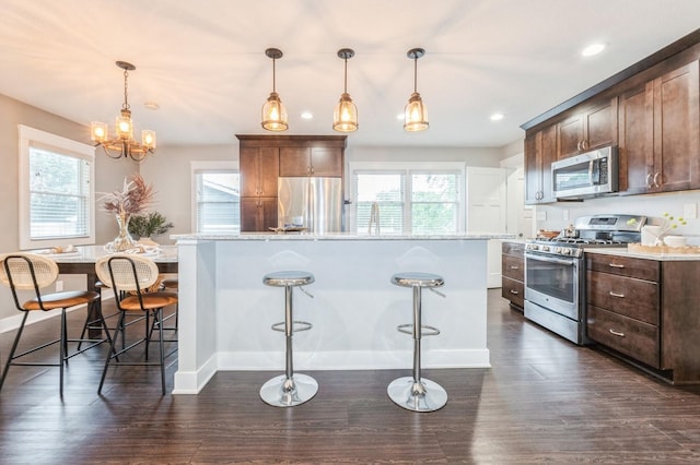 3817 80th St, Urbandale, IA 50322 - kitchen with stainless steel appliances, healthy amount of natural light, dark wood-style flooring, a kitchen island, and recessed lighting