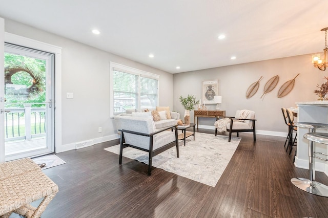 3817 80th St, Urbandale, IA 50322 - living room featuring plenty of natural light, dark wood finished floors, recessed lighting, and a chandelier