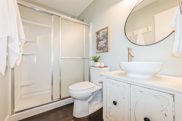 3817 80th St, Urbandale, IA 50322 - bathroom with vanity, a shower stall, and wood finished floors