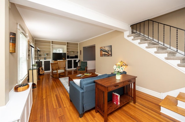 2418 Terrace Rd, Des Moines, IA 50312 - living room featuring stairs, light wood finished floors, and crown molding