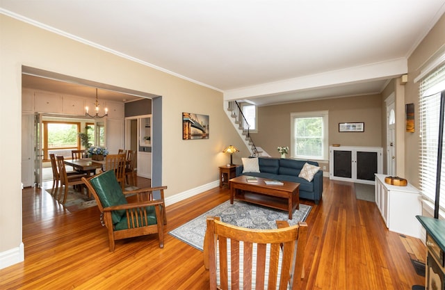2418 Terrace Rd, Des Moines, IA 50312 - living room featuring light wood-type flooring, stairs, a chandelier, and ornamental molding