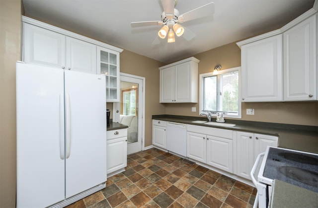 2418 Terrace Rd, Des Moines, IA 50312 - kitchen featuring white appliances, dark stone finish flooring, dark countertops, and white cabinetry