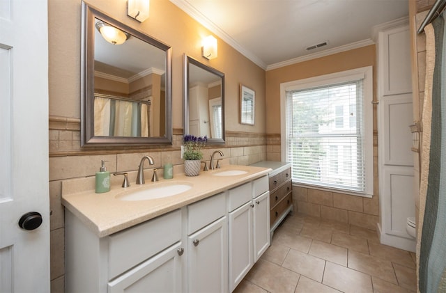 2418 Terrace Rd, Des Moines, IA 50312 - full bath featuring double vanity, crown molding, tile patterned floors, tile walls, and curtained shower