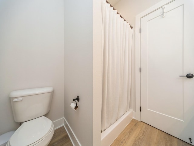 645 NW Prairie Rose Ln, Waukee, IA 50263 - bathroom with wood finished floors and a shower with shower curtain