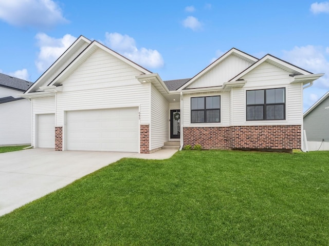 645 NW Prairie Rose Ln, Waukee, IA 50263 - view of front of house featuring brick siding, an attached garage, a front lawn, and driveway