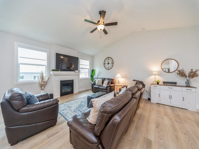 645 NW Prairie Rose Ln, Waukee, IA 50263 - living area with a ceiling fan, light wood-type flooring, vaulted ceiling, and a glass covered fireplace