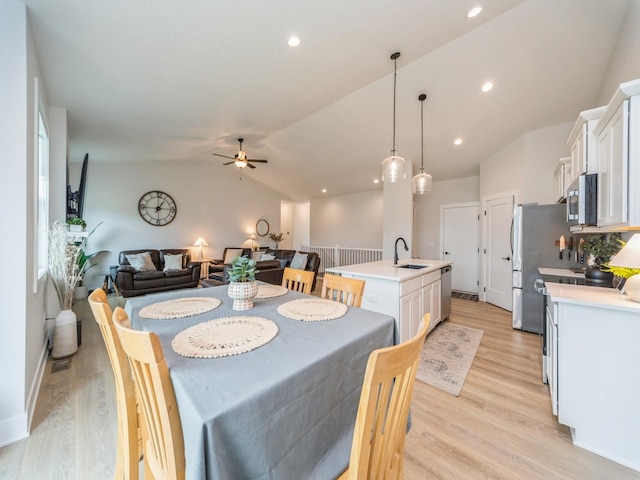 645 NW Prairie Rose Ln, Waukee, IA 50263 - dining room with lofted ceiling, ceiling fan, light wood-style floors, and recessed lighting